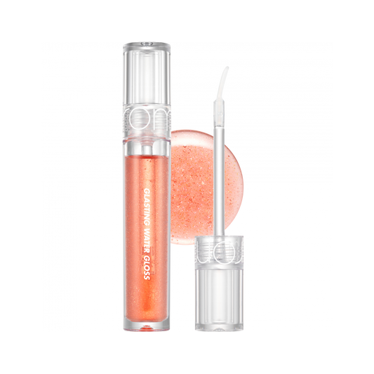 rom&nd Glasting Water Gloss in a shimmering soft peach shade, with a wand applicator and glistening gloss in the background.