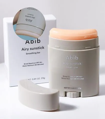 a bottle of airy sunstick next to a box of airy sunstick