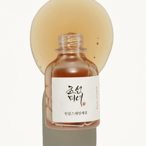 a small bottle of liquid sitting on top of a table