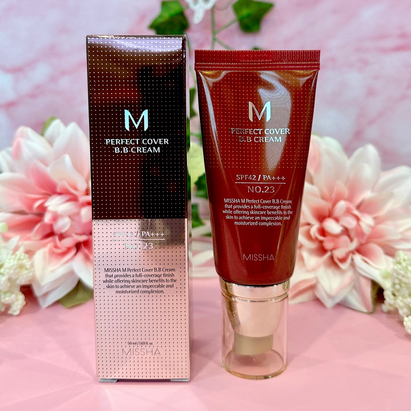 Missha M Perfect Covering BB Cream SPF 42 PA++ No 23 Natural Beige in its packaging, paired with floral accents, presenting a fresh beauty aesthetic.
