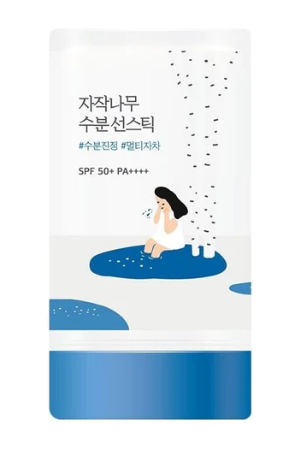 Close-up view of Round Lab Birch Juice Moisturizing Sun Stick, showcasing its artistic design with a girl relaxing near a birch tree, emphasizing its SPF 50+ PA++++ UV protection benefits.