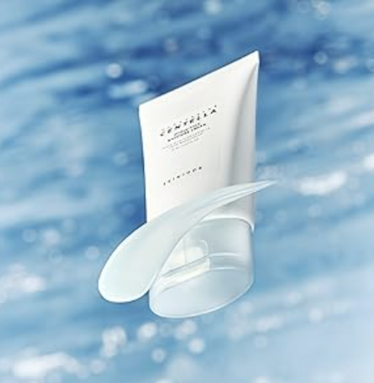 The Skin1004 Madagascar Centella Hyalu-Cica Water-Fit Sun Serum against a blue ocean backdrop, emphasizing its refreshing, hydrating properties ideal for sensitive skin.