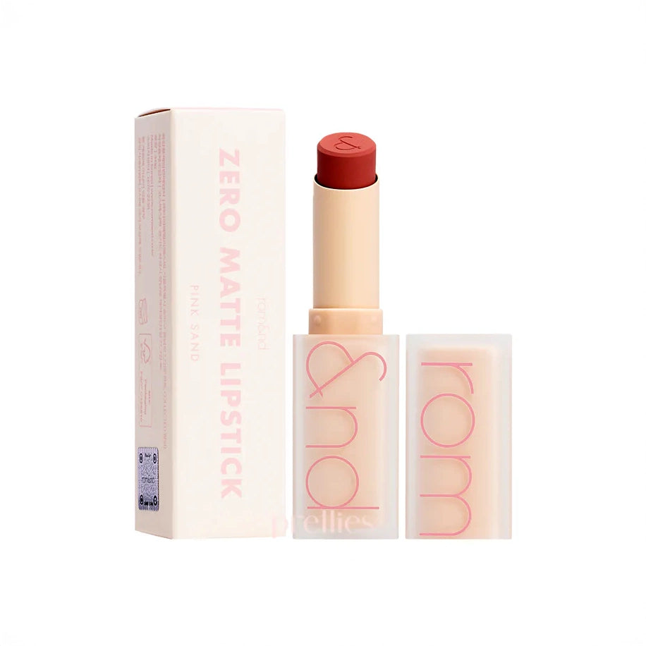 rom&nd Zero Matte Lipstick displayed with a sleek, transparent case showcasing a weightless matte finish in the shade Pink Sand. Ideal for long-lasting color and moisturizing texture.
