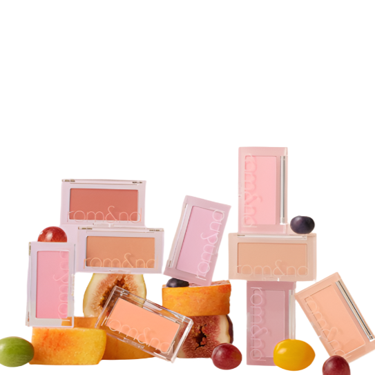 A colorful arrangement of rom&nd Better Than Cheek blushes in various soft-matte shades, surrounded by fresh fruit slices, showcasing vibrant hues perfect for enhancing your natural beauty. Ideal for achieving a radiant glow and a fresh complexion.