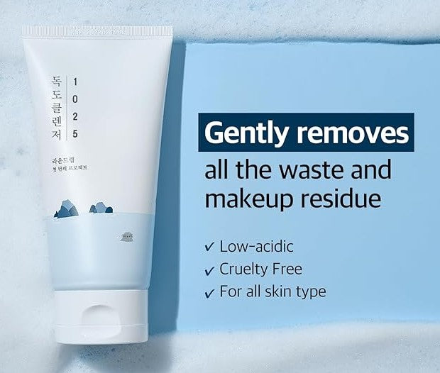 Round Lab 1025 Dokdo Cleanser tube displaying text about its low-acidic formula, suitable for all skin types, focusing on gentle makeup removal.