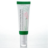 a tube of cream sitting on top of a white table