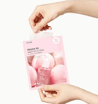 a person holding a package of pink balls