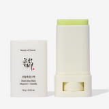 a white tube next to a white container