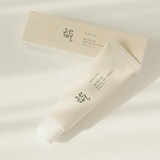 a tube of cream sitting next to a box