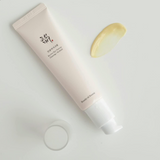 a tube of cream sitting next to a half of a lemon