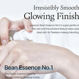 A close-up shot of a hand applying Mixsoon Bean Essence to skin, illustrating its smooth application and glowing finish—truly a skin savior!