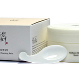 a white container with a spoon next to it