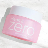 a pink jar of cleanser sitting on top of a white surface