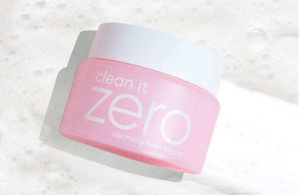 a pink jar of cleanser sitting on top of a white surface