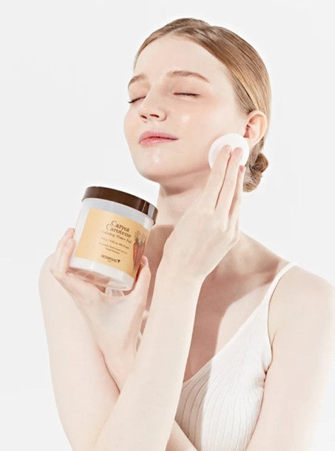 Model using Skinfood Carrot Carotene Calming Water Pad on her face, highlighting hydration and soothing benefits for sensitive skin.
