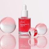 a bottle of red liquid sitting on top of a table