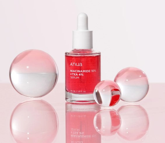 a bottle of red liquid sitting on top of a table