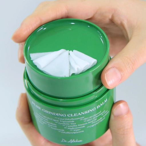 a person holding a green container with a white cloth in it