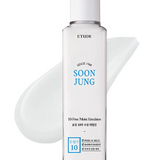 a bottle of liquid sitting on top of a white surface