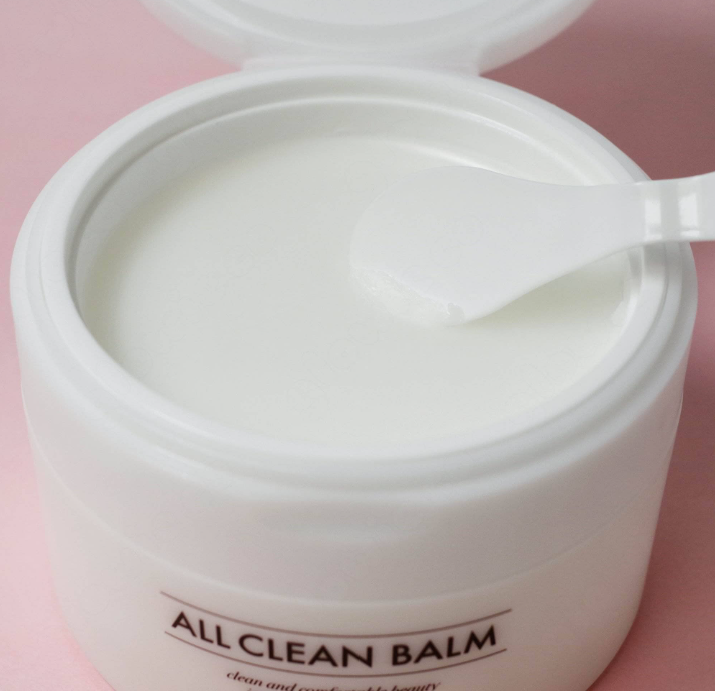 a white container with a spoon inside of it