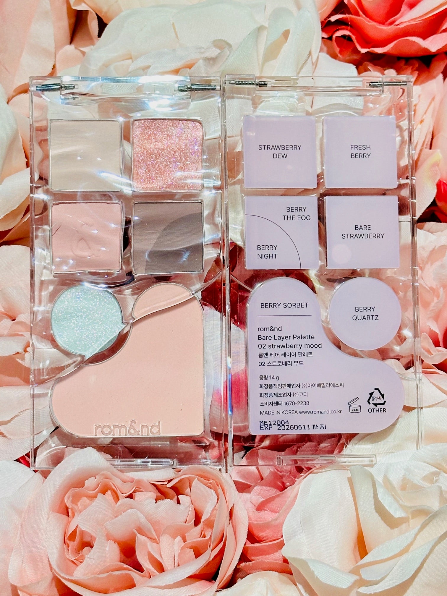 The rom&nd Bare Layer Mood Palette featuring the Strawberry Mood collection, opened to reveal its delightful shades and names on a floral background.