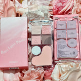 The rom&nd Bare Layer Mood Palette nestled among soft pink roses, highlighting the aesthetic charm of its Strawberry Mood design.