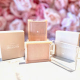 rom&nd See-Through Veil Lighter with an open compact, displaying the shimmering highlighter alongside its stylish packaging.