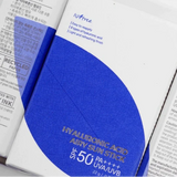 three packages of toothpaste sitting on top of each other