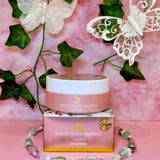 The JayJun Roselle Tea Eye Gel Patch jar set against a whimsical backdrop adorned with butterflies and floral decor. This charming presentation highlights the restorative benefits of these Eye Gel Patches.