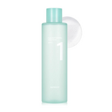 Numbuzin Pure Full Calming Herb Toner bottle elegantly displayed with a splash of toner beside it, promising hydration and soothing properties for sensitive skin.