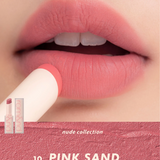 Vibrant view of rom&nd's Zero Matte Lipstick in use, featuring the Pink Sand shade on soft, smooth lips, emphasizing its cool-toned pink base from the nude collection.