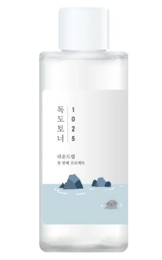 Round Lab 1025 Dokdo Toner in a clear bottle showcasing a modern, simplistic label with ocean elements, emphasizing its nourishing and hydrating properties.