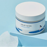 Stylish presentation of Round Lab Birch Juice Moisturizing Pad on a bright background, showcasing the jar and a single pad, illustrating its refreshing and moisturizing properties.