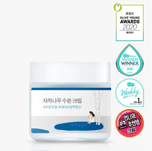 Round Lab Birch Juice Moisturizing Pad jar adorned with various beauty awards, symbolizing its recognition and effectiveness, featuring artistic illustrations and branding elements.