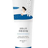 Close-up of Round Lab Birch Juice Moisturizing Sun Cream SPF 50+ showcasing its elegant packaging featuring a woman and birch tree motif.