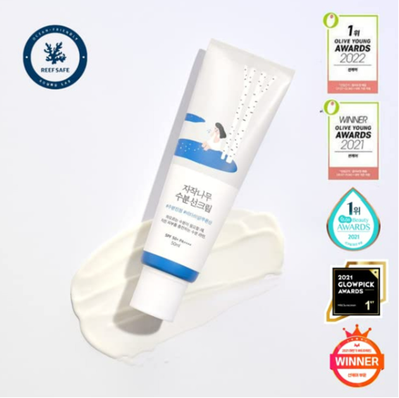 Round Lab Birch Juice Moisturizing Sun Cream SPF 50+ displayed on a flat surface with awards, emphasizing its recognition for quality skin care.