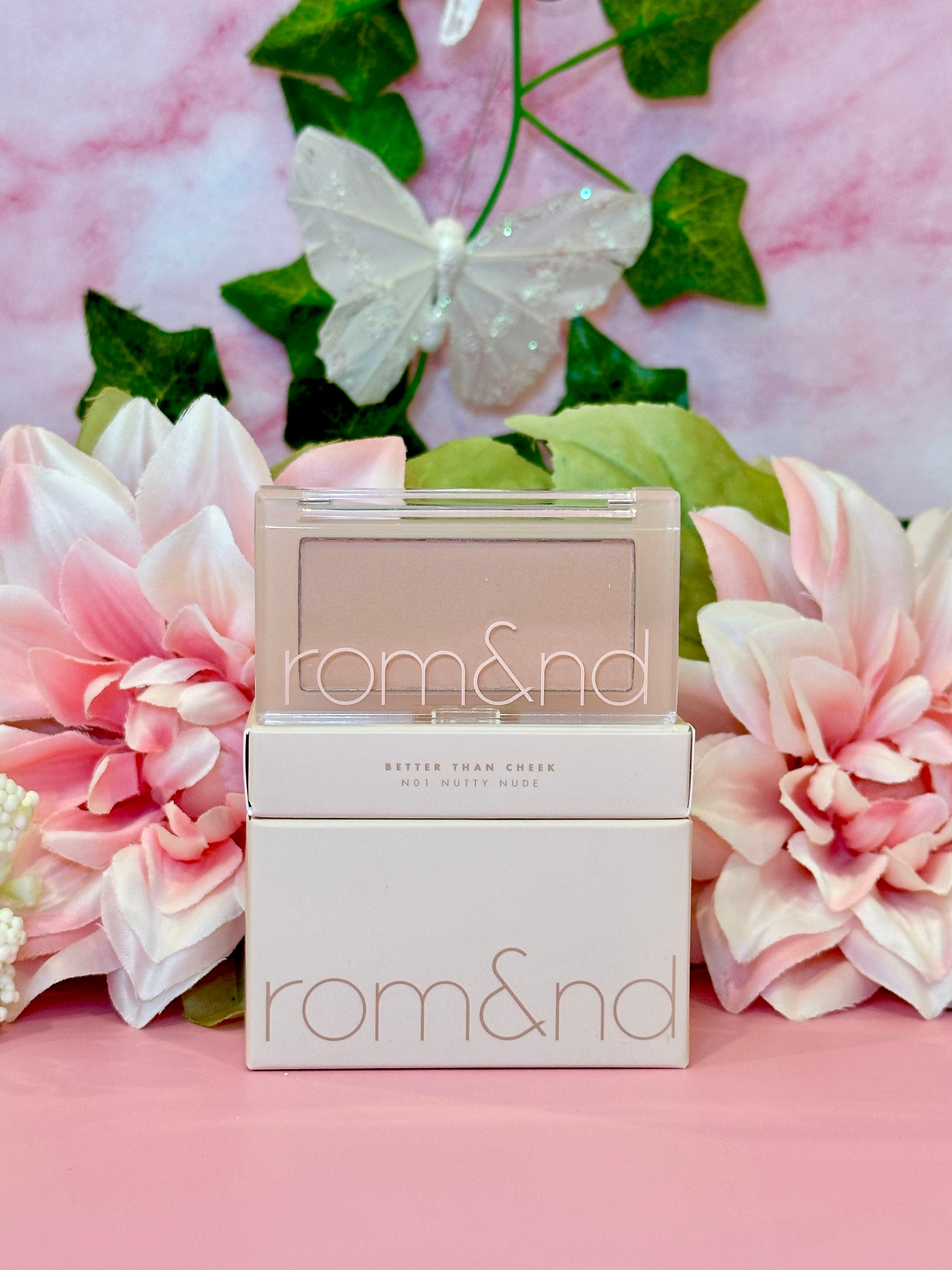 Rom&nd Better Than Cheek blush in N01 Nutty Nude, elegantly presented with floral accents, perfect for adding a subtle touch of color to your makeup routine.