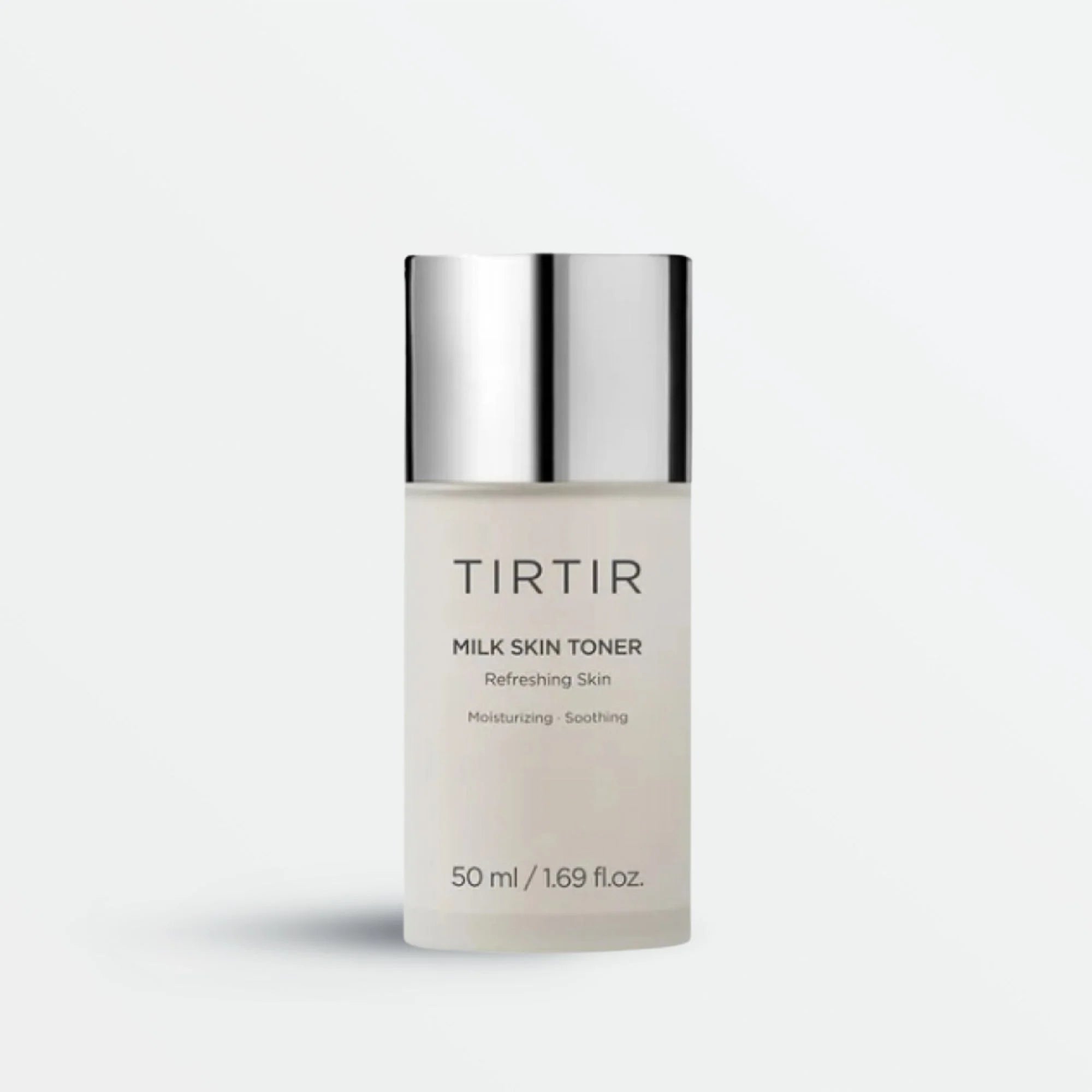 Tirtir Milk Skin Toner in a sleek frosted bottle with silver cap, showcasing its moisturizing and soothing properties for refreshing skin hydration.