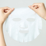 Hands holding a translucent sheet mask representing the Torriden Dive-In Low Molecule Hyaluronic Acid Mask, ideal for showcasing skin rejuvenation and hydration.