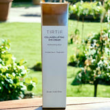 TIRTIR Collagen Lifting Eye Cream displayed in an outdoor setting, with the product packaging highlighted for its refreshing skin treatment attributes.