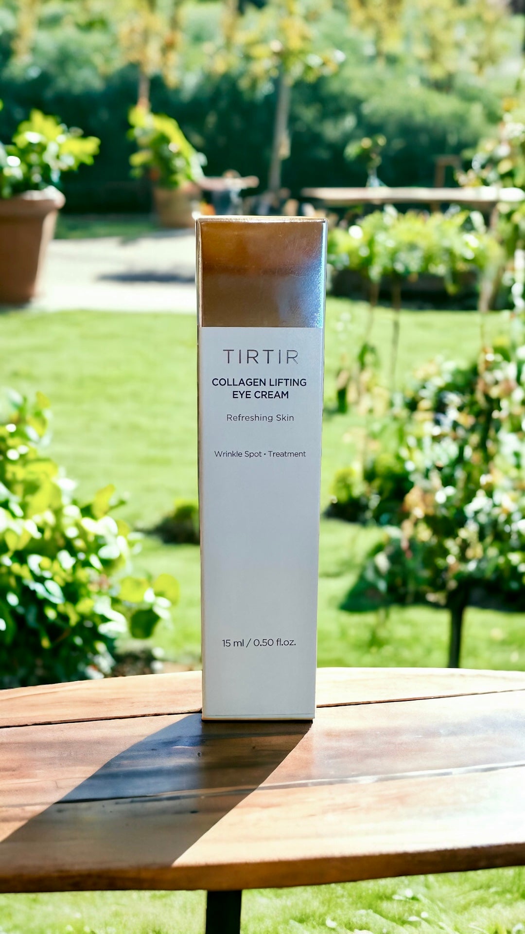 TIRTIR Collagen Lifting Eye Cream displayed in an outdoor setting, with the product packaging highlighted for its refreshing skin treatment attributes.