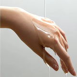a person's hand holding a liquid filled object