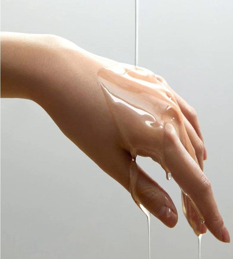 a person's hand holding a liquid filled object