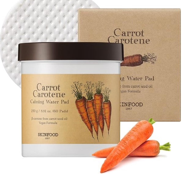 Skinfood Carrot Carotene Calming Water Pad jar alongside fresh carrots, emphasizing its natural ingredients and moisture-rich formula.