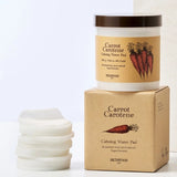 Skinfood Carrot Carotene Calming Water Pad packaging with cotton pads arranged beside it, showcasing its soothing properties for sensitive skin.