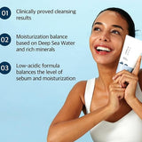 A person smiling and holding Round Lab 1025 Dokdo Cleanser, highlighting its moisture-balancing and clinically proven cleansing benefits.