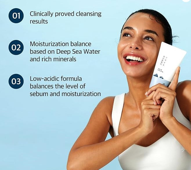 A person smiling and holding Round Lab 1025 Dokdo Cleanser, highlighting its moisture-balancing and clinically proven cleansing benefits.