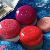 three bath bombs sitting on top of a blue blanket