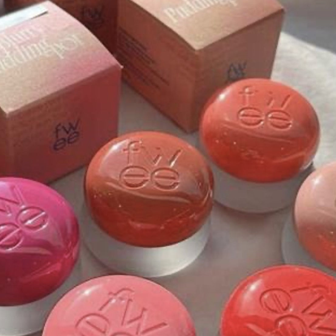 a table topped with different types of lipstick