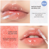 Close-up of glossy lips with rom&nd Glasting Water Gloss, showcasing the Meteor Track shade adorned with sparkling blue pearls.